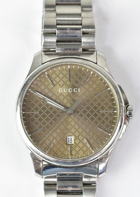 Lot 1313 - GUCCI; a gentlemen's G-Timeless brown dial...