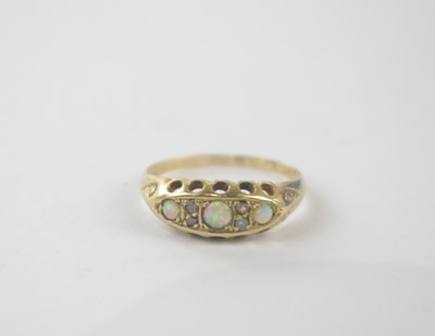 Lot 156 - An 18ct yellow gold opal and diamond chip ring,...