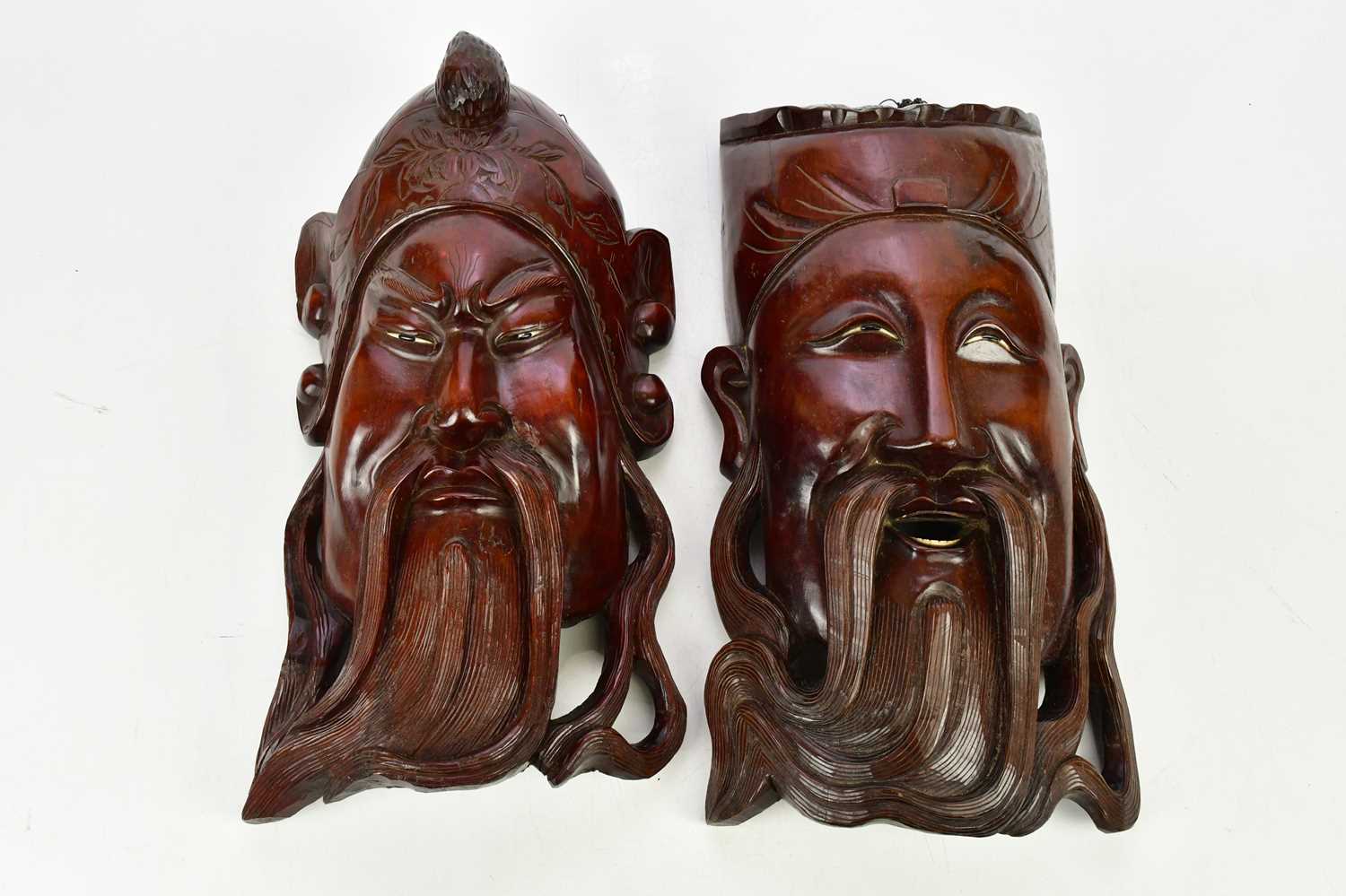 Lot 2712 - A pair of Japanese carved wood wall masks