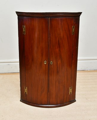 Lot 1120 - A 19th century mahogany bowfront hanging...