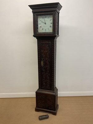 Lot 698 - A carved oak longcase clock, with painted dial...