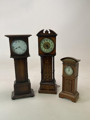 Lot 696 - Three miniature longcase clocks, one in...