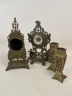 Lot 700 - A decorative brass clock garniture and a...