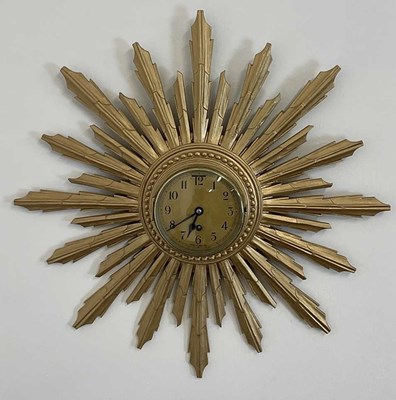 Lot 710 - A reproduction gilt sunburst wall clock with...