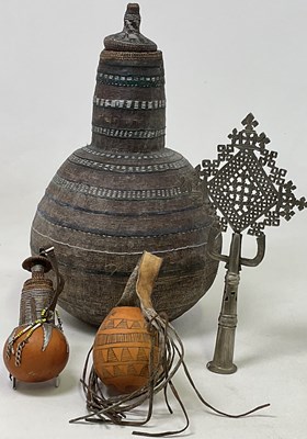 Lot 9 - An Ethiopian gourd milk vessel with woven...