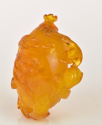 Lot 269 - A Chinese carved amber relief decorated snuff...