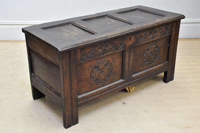 Lot 1154 - An 18th century oak coffer with carved and...