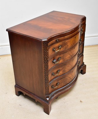Lot 1169 - A reproduction mahogany serpentine front chest...