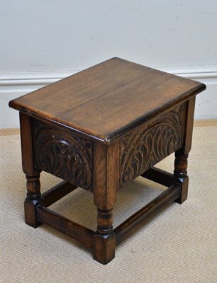 Lot 1209 - A carved oak sewing table/stool with hinged...