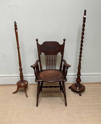 Lot 1114 - An American stick back leather seated elbow...