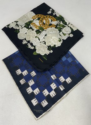 Lot 83 - CHANEL; a silk scarf with white floral design...