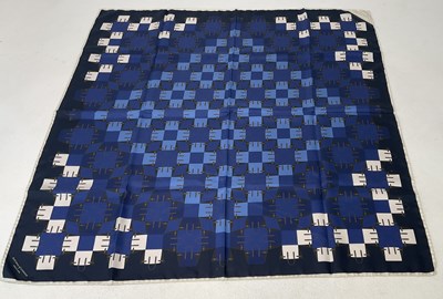 Lot 83 - CHANEL; a silk scarf with white floral design...