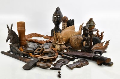 Lot 1182 - A collection of hardwood carved figures and...