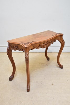 Lot 1192 - A French style carved walnut console table, on...