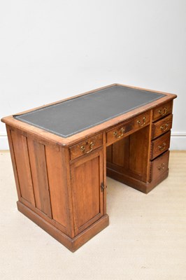 Lot 1047 - An early 20th century oak knee-hole desk, with...