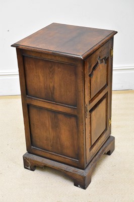 Lot 1193 - A reproduction oak revolving cabinet, with...