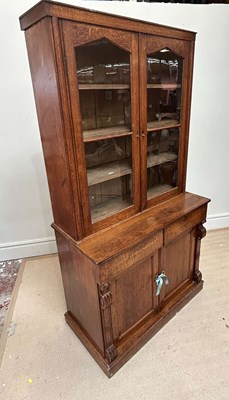 Lot 1011 - A Victorian oak bookcase with arched glazed...