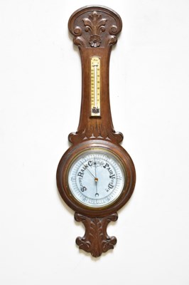 Lot 1362 - An early 20th century carved oak aneroid...