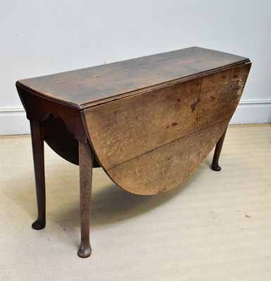Lot 1071 - An 18th century oak oval drop-leaf table on...