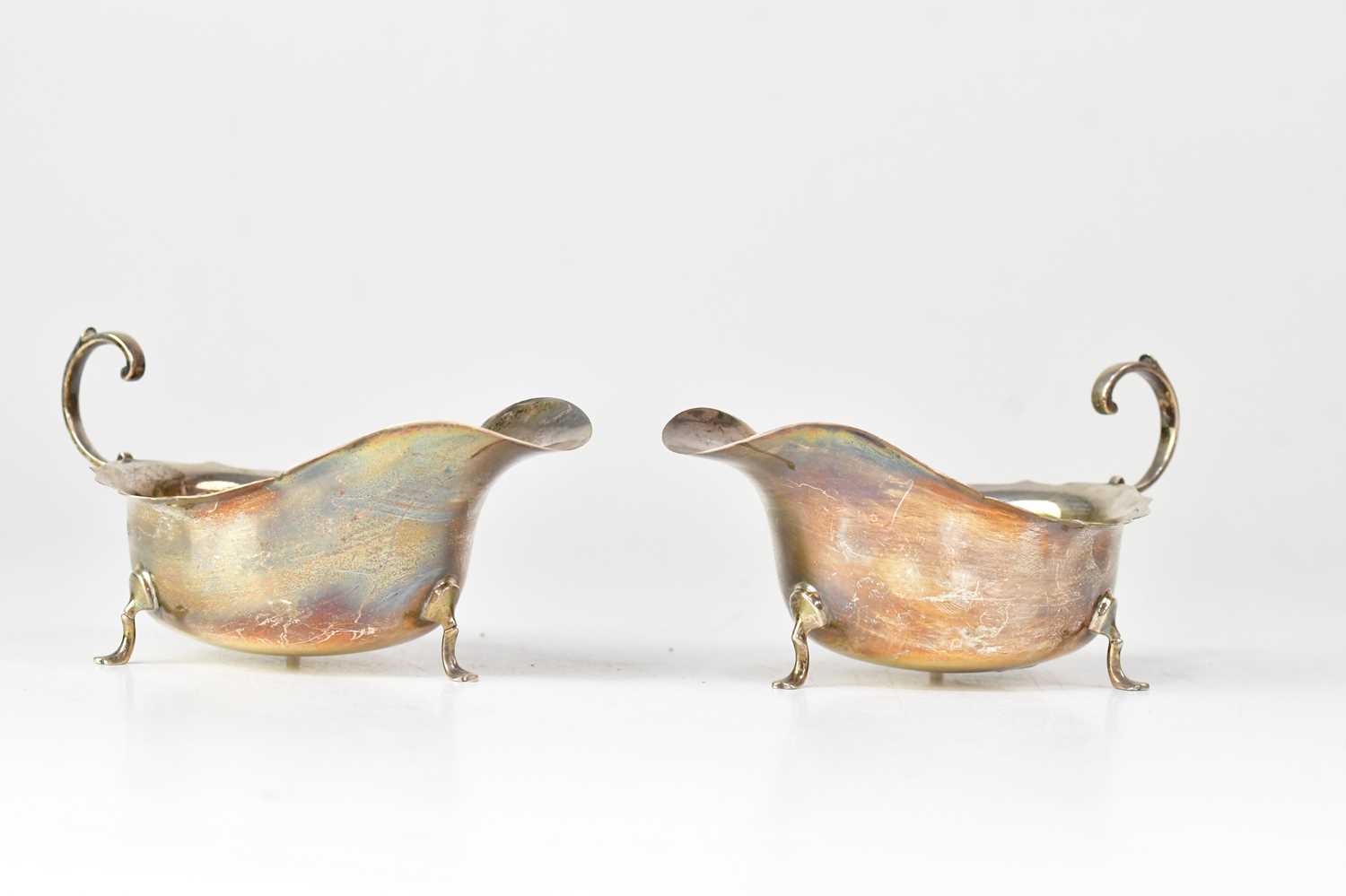 Lot 938 - A pair of George V sauce boats with flying...