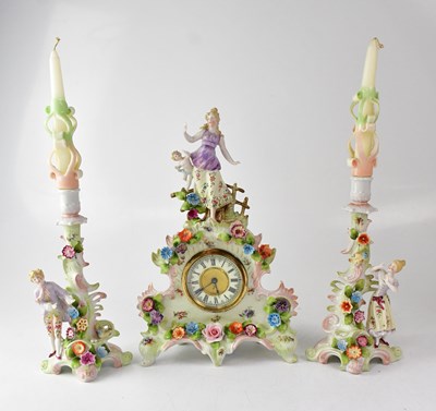 Lot 157 - A 19th century style porcelain clock garniture...