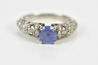 Lot 48 - An 18ct white gold sapphire and diamond ring...