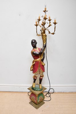 Lot 610 - A modern painted and gilt wood blackamoor...