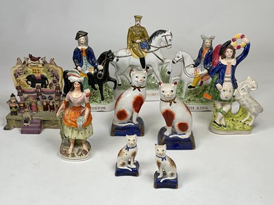 Lot 230 - A collection of Staffordshire flatback figures...