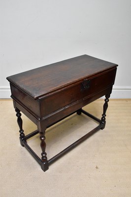Lot 1144 - An 18th century oak box on stand, the hinged...