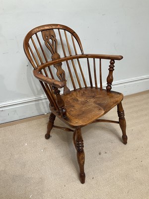 Lot 1149 - A 19th century elm seated low back Windsor...
