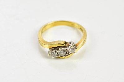 Lot 74 - An 18ct yellow gold three stone diamond ring...