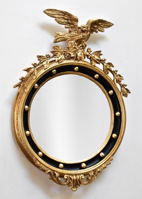Lot 1167 - A Regency style gilt and black convex wall...