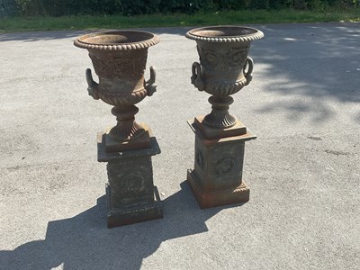 Lot 1259 - A pair of reproduction cast iron twin handled...