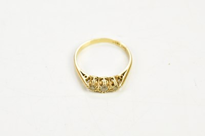 Lot 146 - An 18ct yellow gold diamond three stone ring,...