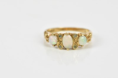 Lot 178 - A 9ct yellow gold diamond and opal dress ring,...