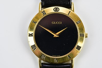 Lot 635 - GUCCI; a boxed gold plated fashion watch,...
