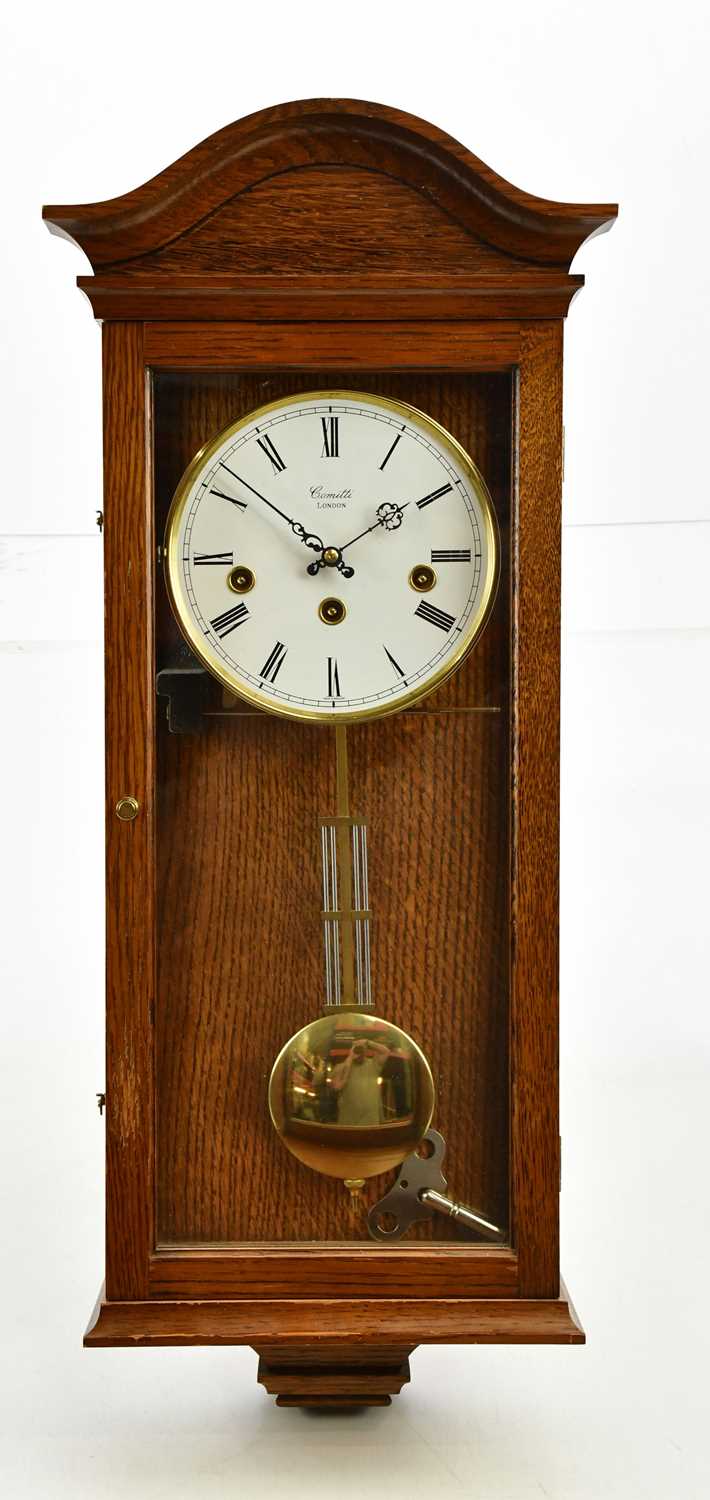 Lot 1307 - COMITTI; a modern oak eight day wall clock,...