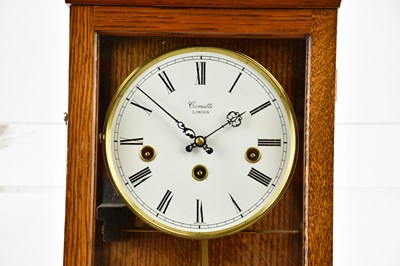 Lot 1307 - COMITTI; a modern oak eight day wall clock,...