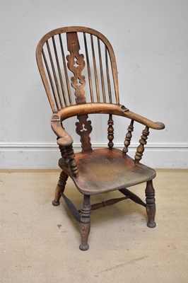 Lot 91 - A 19th century elm seated Windsor elbow chair...