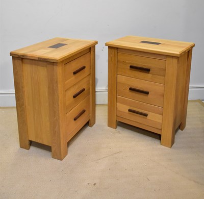 Lot 55 - A pair of modern light oak three drawer chests...