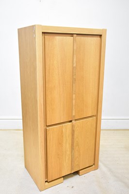 Lot 63 - A modern oak two door cupboard on block feet,...