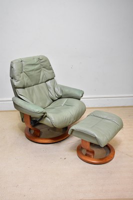 Lot 43 - STRESSLESS; a leather armchair with stool.