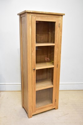 Lot 53 - A modern light oak display cabinet, with...