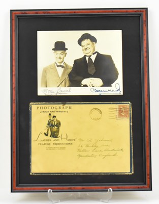 Lot 1627 - LAUREL & HARDY; a framed display of a black...