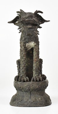 Lot 322 - A bronze statue of a seated dragon, raised on...