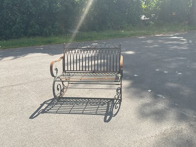 Lot 1280 - A modern black painted rocking bench.