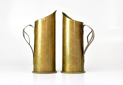 Lot 421 - A pair of trench art jugs, both inscribed...