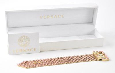 Lot 1264 - VERSACE; a pink stone set buckle clasp...