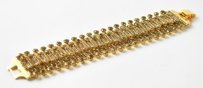 Lot 1262 - CAROLINA HERRERA; a gilt metal and white stone...