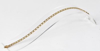 Lot 621 - A 9ct gold flat link bracelet with lobster...